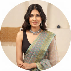 Portrait of Shilpa Sharma wearing a sea green handblock Kota Doriya saree with golden border details.