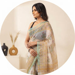 Dolly Jain wearing a sea green Kota Doriya handblock saree with small butti prints and a golden border against a neutral back