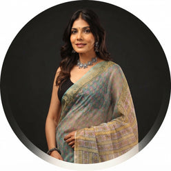 Mini Mathur wearing a sea green handblock Kota Doriya saree with gold border in a professional portrait.